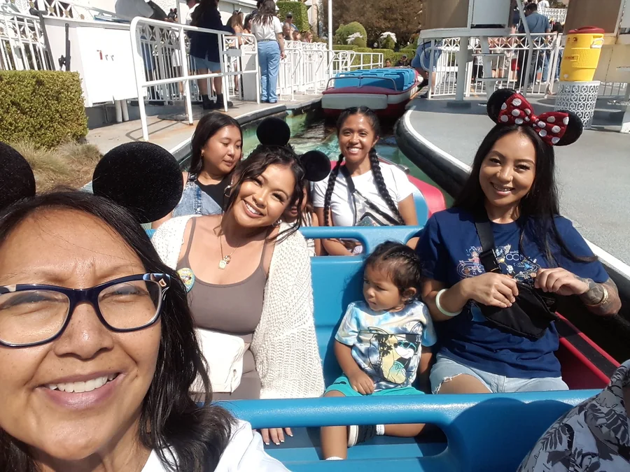Family enjoying a One More Moment experience together on a theme park ride
