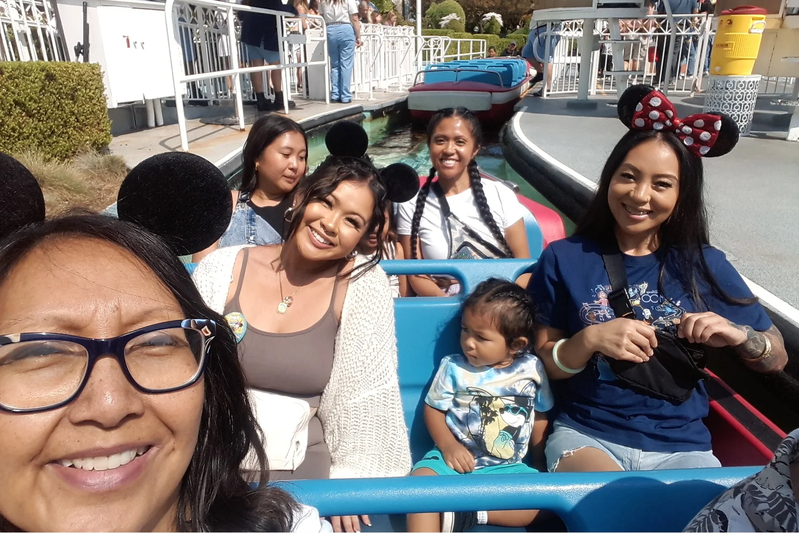 Family enjoying a One More Moment experience together on a theme park ride